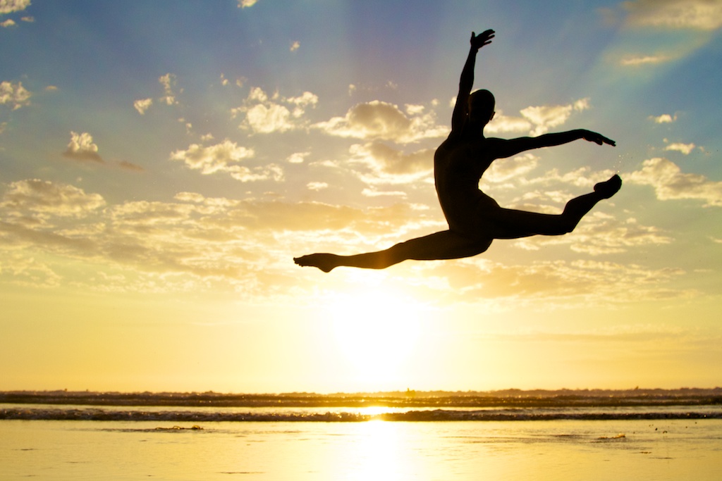 Nude model dancing with sunset